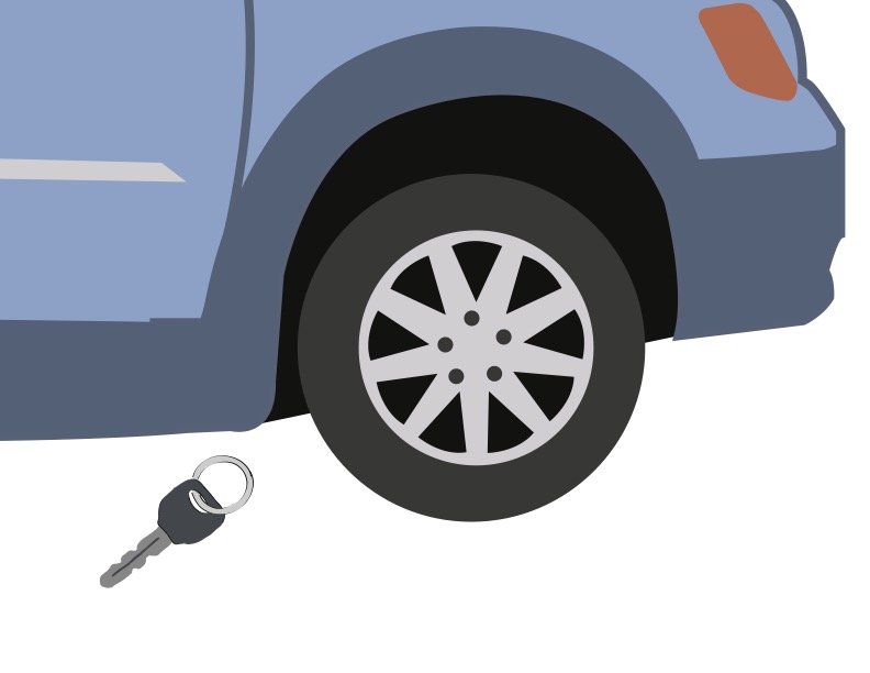 A blue van tire with keys on the ground nearby.